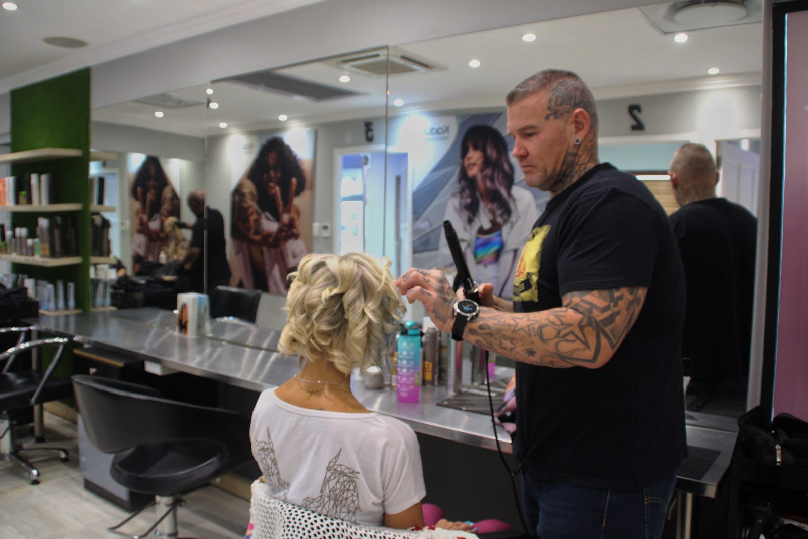 Hairdresser styling a client in a salon
